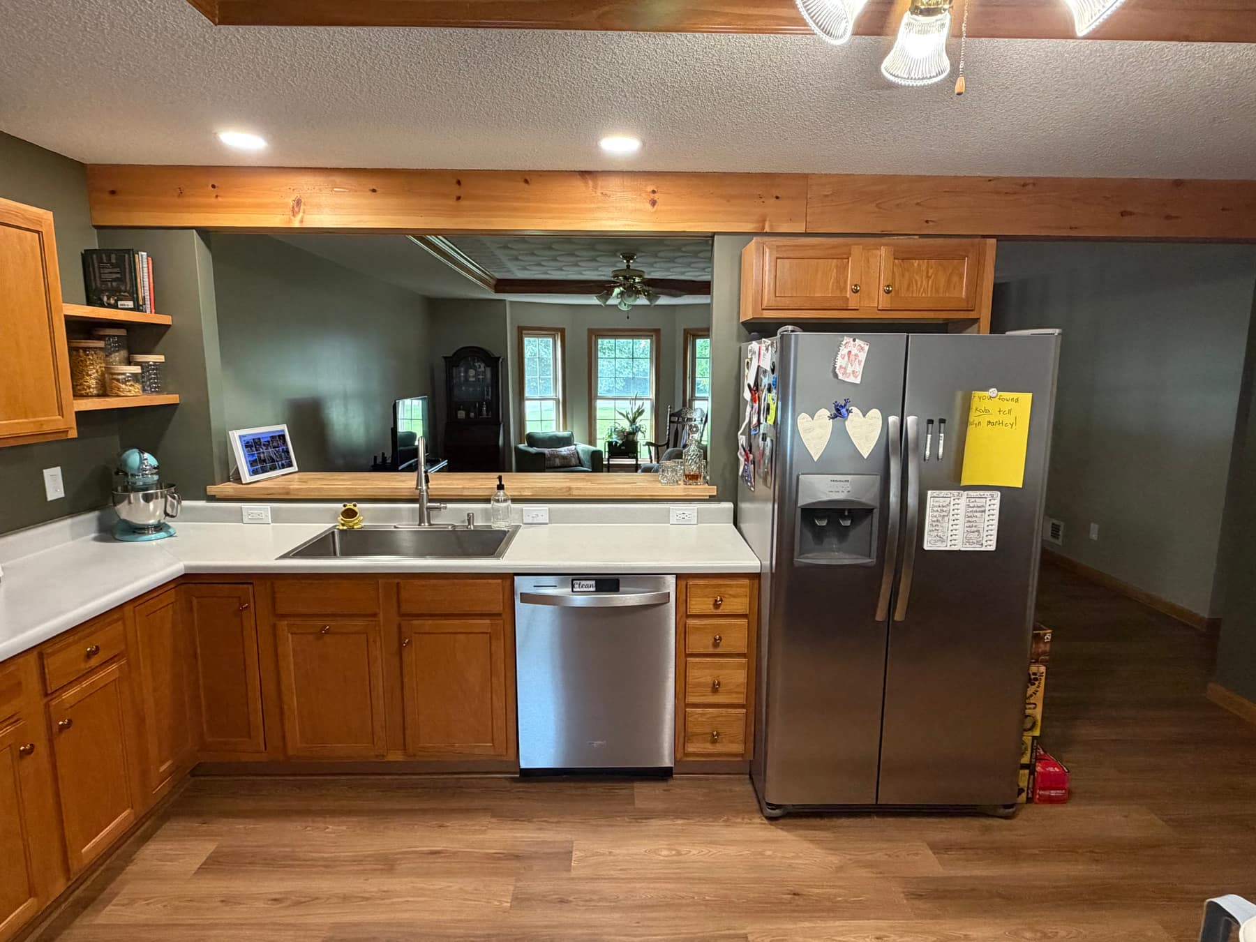 Finished open-concept kitchen with exposed wood beam and pass-through counter
