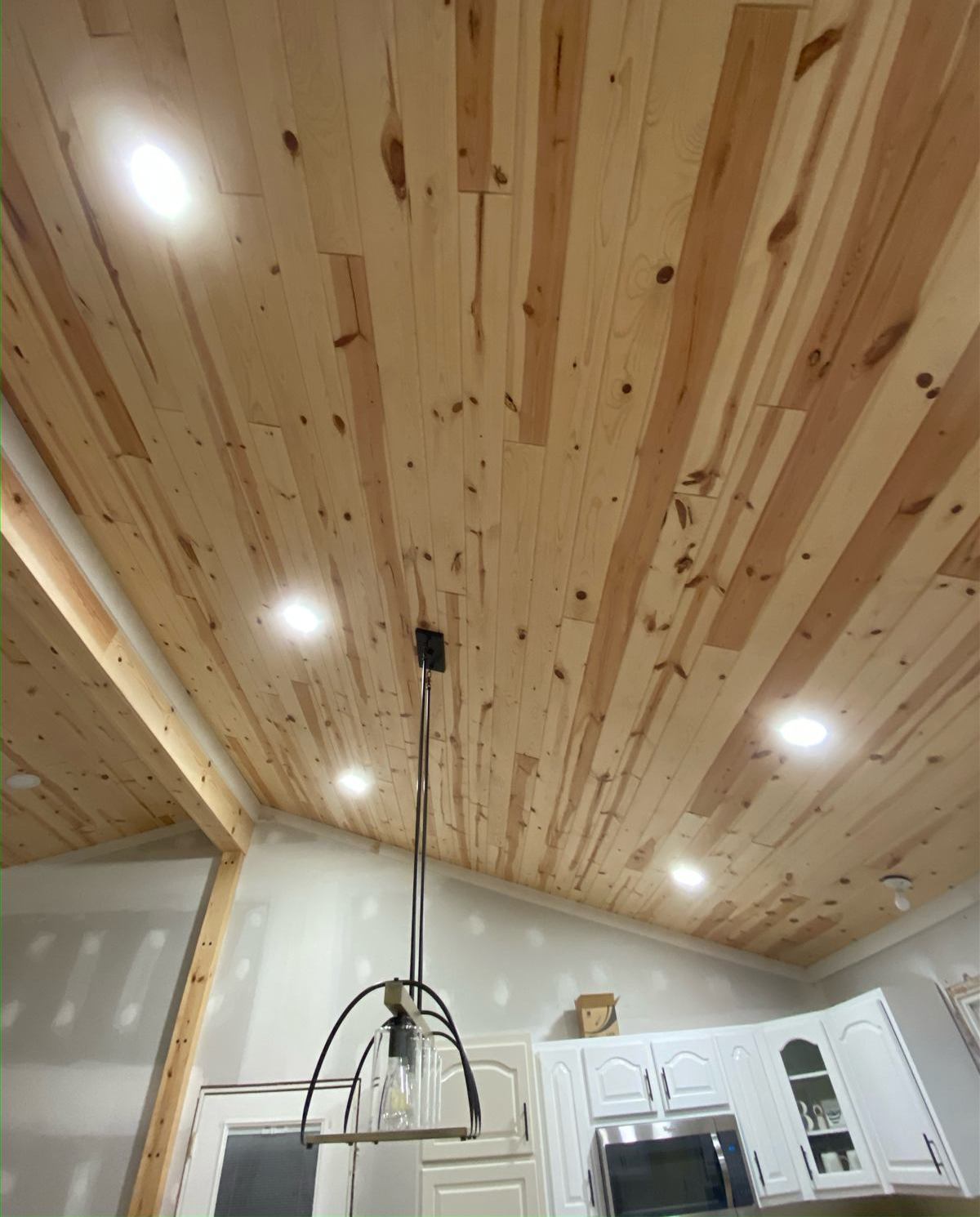 Second angle of the vaulted pine ceiling with pendant light over the kitchen