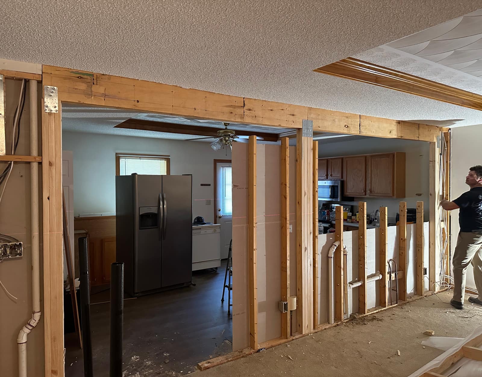 Load-bearing wall being removed and replaced with a beam between kitchen and living room